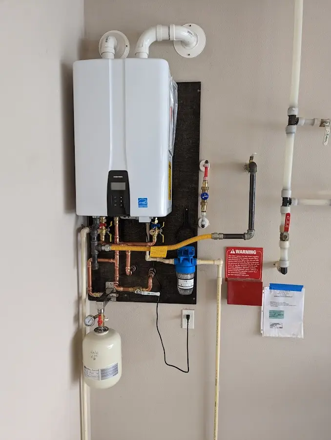 Professional plumber installing copper piping in a Columbia Heights home